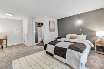 A bedroom with a bed and a rug